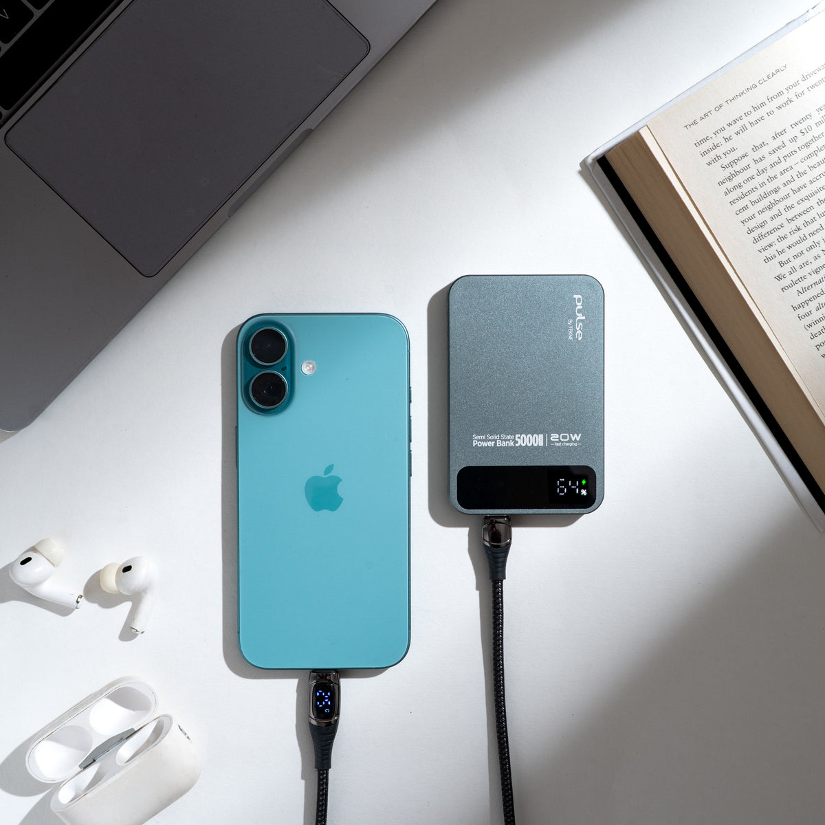 Power Tekne bank 5000mAh charging teal iPhone with AirPods and laptop on white desk