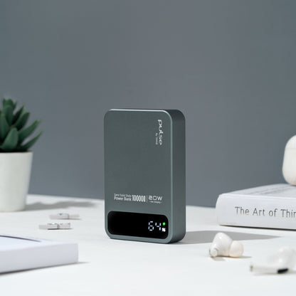 Pulse Tekne 20W power bank with 64% display on desk with earbuds and book